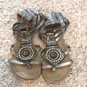 City Classified Size 9 gladiators. Silver with studs. Worn with minor tears.